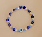 Pulsera Ojos azules con perlas blancas